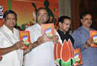 BJP promises free laptops, rice at Rs one