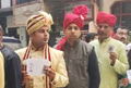 Groom, family dressed for wedding, stand in queue to vote in Delhi