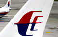 Malaysia signals missing plane has crashed; probes false IDs