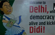 Posters welcoming Mamata Banerjee to Delhi,Smile Didi, you are in a democracy