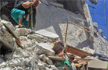 Syrian Girl gripping baby sister’s shirt as she dangles from bombed building